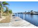Private wooden dock featuring boat lift access on a canal with lush landscaping at 121 Sinclair Se St, Port Charlotte, FL 33952
