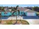 Charming, turquoise single-story home featuring a well-manicured lawn and spacious driveway at 121 Sinclair Se St, Port Charlotte, FL 33952