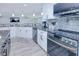 Spacious kitchen featuring granite countertops, stainless steel appliances, and ample cabinet space at 121 Sinclair Se St, Port Charlotte, FL 33952