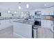 Bright, modern kitchen with center island, granite countertops, and stainless steel appliances at 121 Sinclair Se St, Port Charlotte, FL 33952