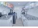 Laundry room featuring granite countertops, white cabinetry, sink, and modern appliances at 121 Sinclair Se St, Port Charlotte, FL 33952