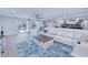 Bright living room with an open floor plan, tile floors, and sliding glass doors to outdoor pool at 121 Sinclair Se St, Port Charlotte, FL 33952