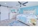 Bright main bedroom with a patterned comforter, and a ceiling fan at 121 Sinclair Se St, Port Charlotte, FL 33952