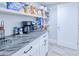 Walk-in pantry featuring granite countertops, white cabinets and shelves for ample storage at 121 Sinclair Se St, Port Charlotte, FL 33952