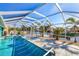 This beautiful in-ground pool has clear blue water and is enclosed by a screened in lanai with boat dock access at 121 Sinclair Se St, Port Charlotte, FL 33952