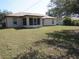 Spacious backyard with white house and screen room addition at 1247 Petronia St, North Port, FL 34286