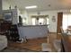 Bright dining area featuring an elegant light fixture, wood-look floors, and sliding doors leading to the patio at 1247 Petronia St, North Port, FL 34286