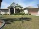 Inviting home featuring a well-manicured lawn, lush landscaping, and a welcoming front entrance at 1247 Petronia St, North Port, FL 34286