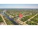 Aerial view of community with tree-lined streets, water access, and houses with private pools in a desirable location at 13356 Rayburn Ln, Port Charlotte, FL 33981
