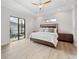 Bright bedroom featuring a tray ceiling, ceiling fan, and sliding doors to the pool area at 13356 Rayburn Ln, Port Charlotte, FL 33981