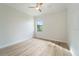 Empty bedroom featuring a ceiling fan, wood look tile flooring and a small window at 13356 Rayburn Ln, Port Charlotte, FL 33981