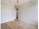 Empty bedroom featuring a ceiling fan, wood look tile flooring and bi-fold doors to the closet at 13356 Rayburn Ln, Port Charlotte, FL 33981