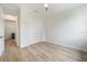 Empty bedroom featuring a ceiling fan, wood look tile flooring and bi-fold doors to the closet at 13356 Rayburn Ln, Port Charlotte, FL 33981