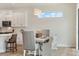 Eat-in dining area features a modern light fixture, hardwood floors, and seating for four at 13356 Rayburn Ln, Port Charlotte, FL 33981