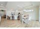 Dining area features a modern light fixture, hardwood floors, and a dining table for four at 13356 Rayburn Ln, Port Charlotte, FL 33981