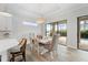 Bright dining room with modern chandelier and a view to the outdoor space at 13356 Rayburn Ln, Port Charlotte, FL 33981