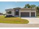 Beautiful single-story home featuring a manicured lawn and a three-car garage at 13356 Rayburn Ln, Port Charlotte, FL 33981