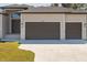 Exterior shot of a three car garage and front door of the house at 13356 Rayburn Ln, Port Charlotte, FL 33981