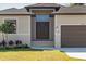 Inviting front entrance with double doors, neutral colors and manicured lawn at 13356 Rayburn Ln, Port Charlotte, FL 33981