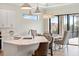 Open kitchen features stainless steel appliances, a large island with white countertop, pendant lighting, and sliding glass doors at 13356 Rayburn Ln, Port Charlotte, FL 33981