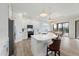 Bright kitchen boasts white cabinets, stainless steel appliances, and an eat-in island with pendant lighting at 13356 Rayburn Ln, Port Charlotte, FL 33981