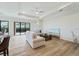 Open-concept living area with hardwood floors, modern furniture, and access to the pool at 13356 Rayburn Ln, Port Charlotte, FL 33981