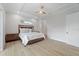 Light-filled main bedroom features wood-look tile flooring, a ceiling fan, and recessed lighting at 13356 Rayburn Ln, Port Charlotte, FL 33981