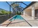Screened-in pool area with an in-ground swimming pool and brick pavers at 13356 Rayburn Ln, Port Charlotte, FL 33981
