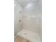 Walk-in shower features elegant tile work, a rainfall showerhead, and a built-in shower bench at 13356 Rayburn Ln, Port Charlotte, FL 33981