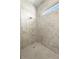 Bathroom featuring white marble tiles, a shower head and a tiled shower floor at 13364 Rayburn Ln, Port Charlotte, FL 33981