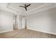 Spacious bedroom with tray ceiling, ceiling fan, wood-look floors, and neutral paint at 13364 Rayburn Ln, Port Charlotte, FL 33981
