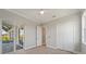 Bedroom featuring wood-look tile flooring, a sliding glass door to the pool, and a closet at 13364 Rayburn Ln, Port Charlotte, FL 33981