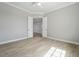 Clean bedroom featuring wood floors, base molding, a ceiling fan, and double doors at 13364 Rayburn Ln, Port Charlotte, FL 33981