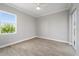 Bedroom with wood-look tile flooring, a window with a view, and a sliding glass door at 13364 Rayburn Ln, Port Charlotte, FL 33981