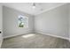 Bright bedroom with wood-look floors and a window offering natural light at 13364 Rayburn Ln, Port Charlotte, FL 33981