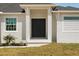 Close up of the front door with nice landscaping and well maintained lawn at 13364 Rayburn Ln, Port Charlotte, FL 33981