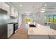 Modern kitchen featuring white cabinetry, stainless steel appliances, and a marble countertop island at 13364 Rayburn Ln, Port Charlotte, FL 33981