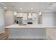 Bright kitchen with stainless steel appliances, white cabinets, island with marble countertop, and pendant lighting at 13364 Rayburn Ln, Port Charlotte, FL 33981