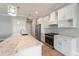 Modern kitchen with stainless steel appliances, island and marble countertops at 13364 Rayburn Ln, Port Charlotte, FL 33981