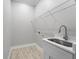 Laundry room with utility sink, modern faucet and drying rack at 13364 Rayburn Ln, Port Charlotte, FL 33981