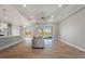 Spacious living room with tray ceiling, ceiling fan, and sliding glass doors leading to the outdoor patio at 13364 Rayburn Ln, Port Charlotte, FL 33981