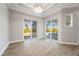 Bright room featuring wood-look flooring, sliding glass doors overlooking the pool, and recessed lighting at 13364 Rayburn Ln, Port Charlotte, FL 33981