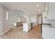 Open-concept living space with kitchen island, stainless steel appliances, and comfortable seating area at 13364 Rayburn Ln, Port Charlotte, FL 33981