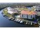 This aerial view shows waterfront condos with boat docks, pool, and lush surroundings at 1340 Rock Dove Ct # 143, Punta Gorda, FL 33950