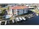 The aerial view shows waterfront condos with boat docks, pool, and beautiful surroundings at 1340 Rock Dove Ct # 143, Punta Gorda, FL 33950