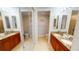 A bathroom featuring double sinks with granite countertops and tiled floors at 1340 Rock Dove Ct # 143, Punta Gorda, FL 33950