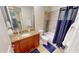 Bathroom featuring granite countertop, tile floor and shower/tub with blue shower curtain at 1340 Rock Dove Ct # 143, Punta Gorda, FL 33950