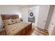 Bedroom featuring wood flooring, cozy decor, and open access to other rooms at 1340 Rock Dove Ct # 143, Punta Gorda, FL 33950