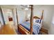 Bedroom with hardwood floors and four poster bed located near closet and bathroom at 1340 Rock Dove Ct # 143, Punta Gorda, FL 33950