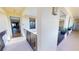 Well-lit hallway with view to living area, unit number, and black iron railing at 1340 Rock Dove Ct # 143, Punta Gorda, FL 33950